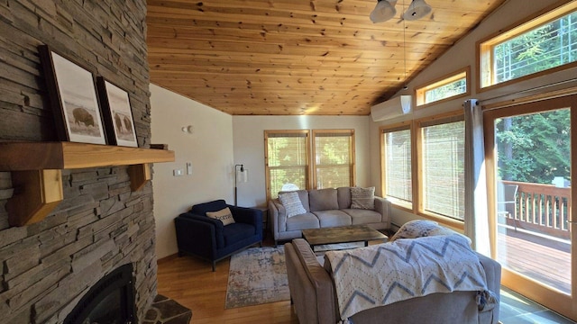 living room featuring a wall mounted AC, a stone fireplace, wooden ceiling, vaulted ceiling, and hardwood / wood-style flooring