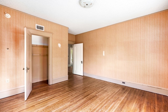 unfurnished bedroom with a closet and light hardwood / wood-style floors