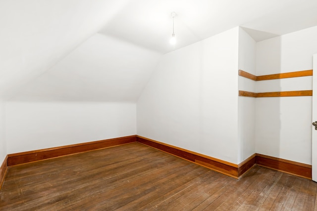 additional living space featuring hardwood / wood-style flooring and vaulted ceiling