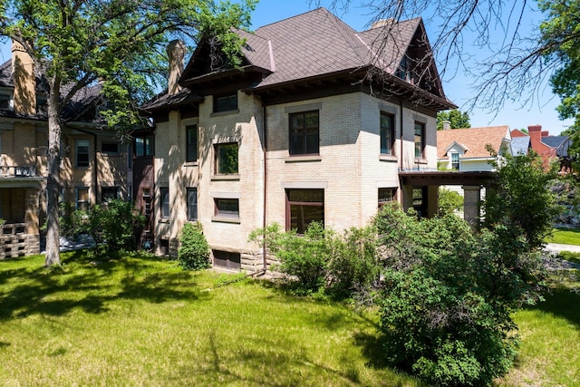 rear view of house with a yard