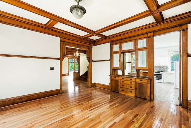 spare room with coffered ceiling, wood-type flooring, and plenty of natural light