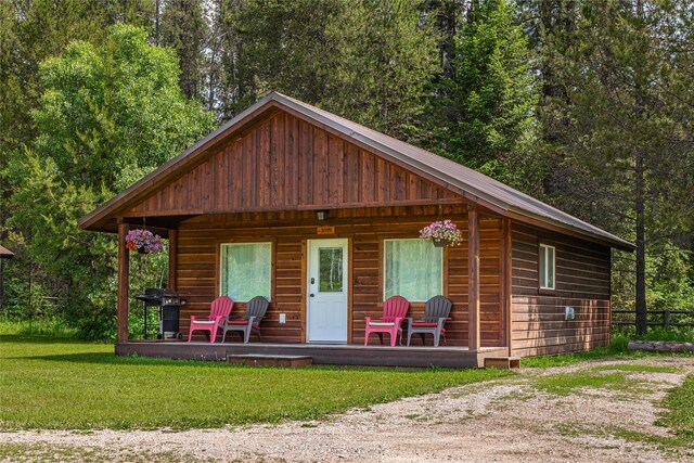 exterior space with a yard and covered porch