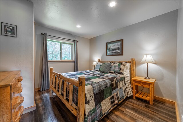 bedroom with dark wood-type flooring