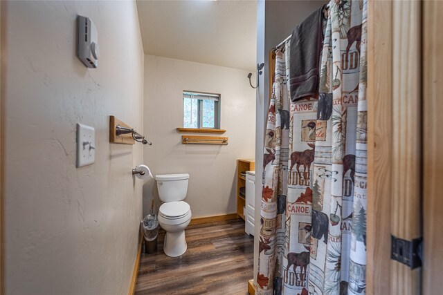 bathroom featuring vanity, toilet, hardwood / wood-style flooring, and curtained shower