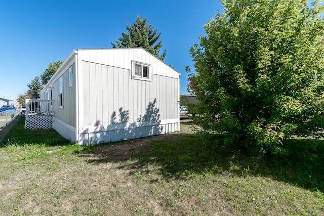 view of side of home with a lawn