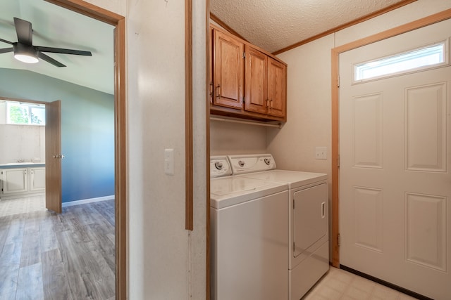 laundry area with plenty of natural light, cabinets, ceiling fan, and light hardwood / wood-style floors