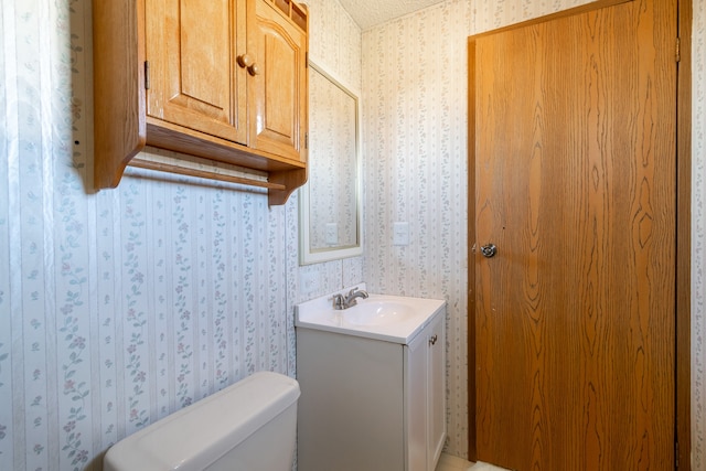 bathroom featuring toilet and vanity