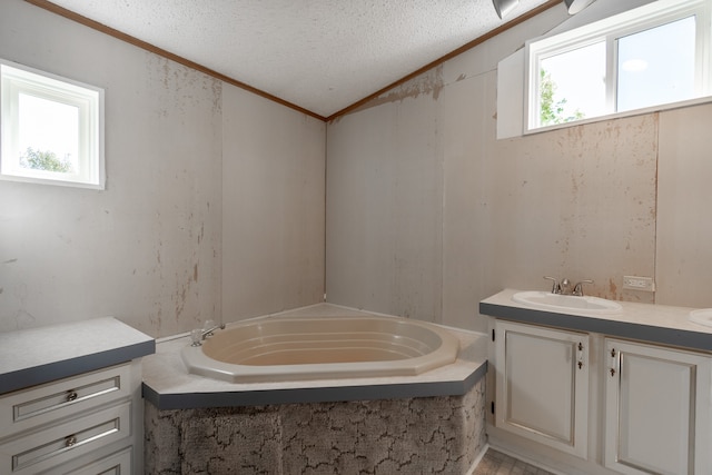 bathroom with a wealth of natural light, a bathing tub, crown molding, and vaulted ceiling