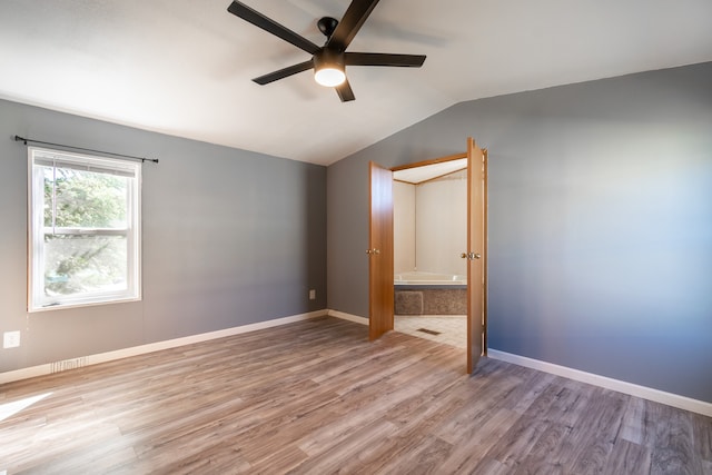 unfurnished bedroom with vaulted ceiling, wood-type flooring, and ceiling fan