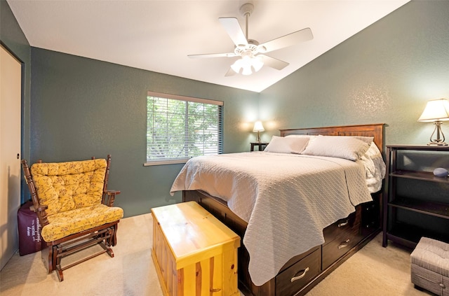 bedroom with light carpet, vaulted ceiling, a ceiling fan, and a textured wall