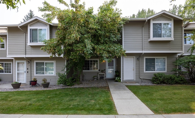 view of property featuring a front lawn