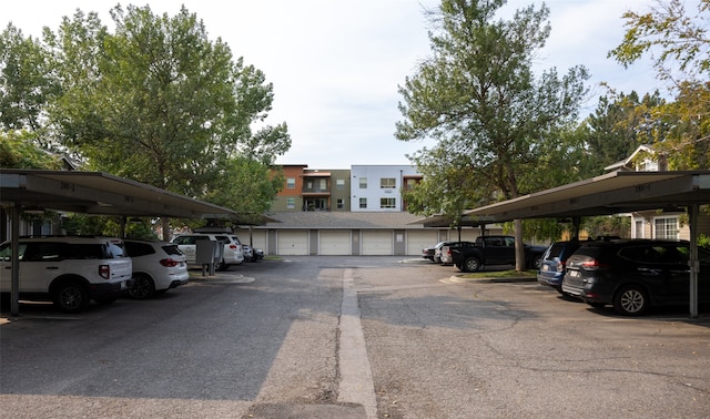 view of car parking featuring a garage and a carport