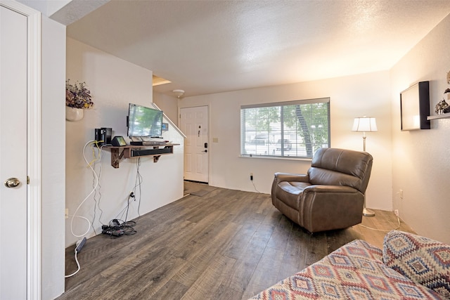 sitting room featuring dark hardwood / wood-style floors and a textured ceiling