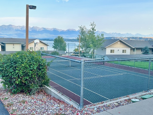 view of tennis court featuring a mountain view