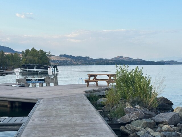 view of dock featuring a water and mountain view