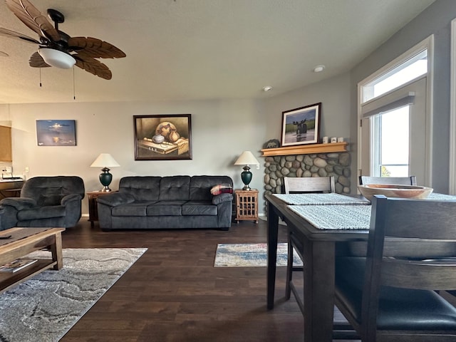 living room featuring ceiling fan and dark hardwood / wood-style flooring