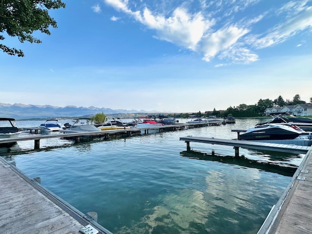 view of dock with a water and mountain view