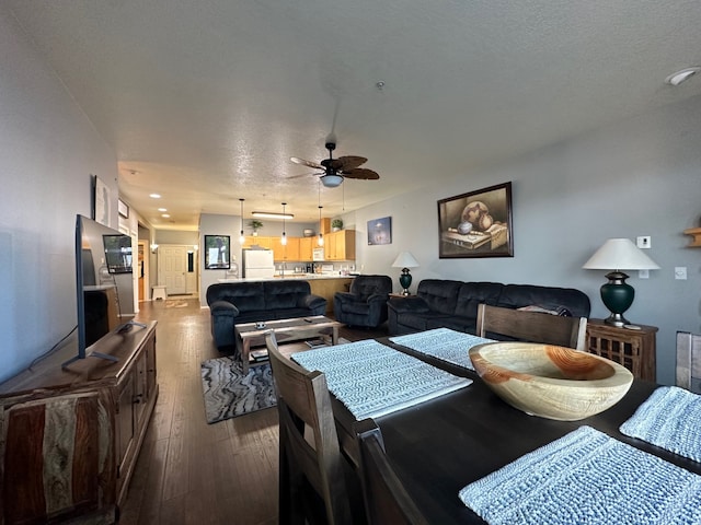 dining area featuring hardwood / wood-style flooring, a textured ceiling, and ceiling fan