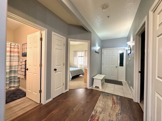 hall featuring hardwood / wood-style flooring and a textured ceiling