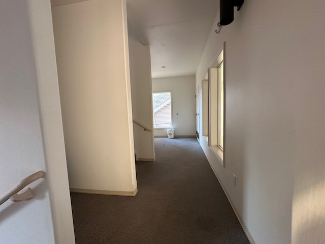 hallway featuring dark carpet