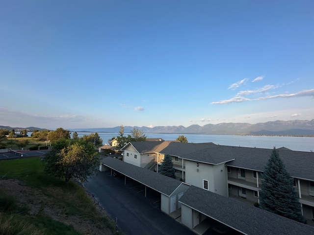 birds eye view of property featuring a water and mountain view