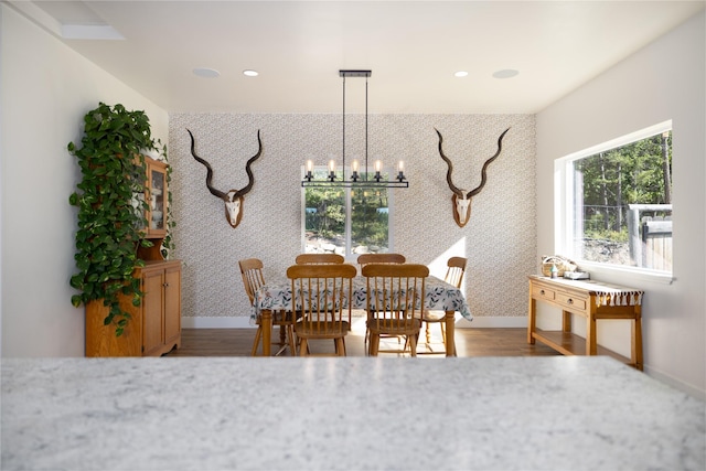 965 Ksanka Foothills Rd, Eureka, MT 59917 - dining room with wood finished floors, baseboards, wallpapered walls, recessed lighting, and an inviting chandelier