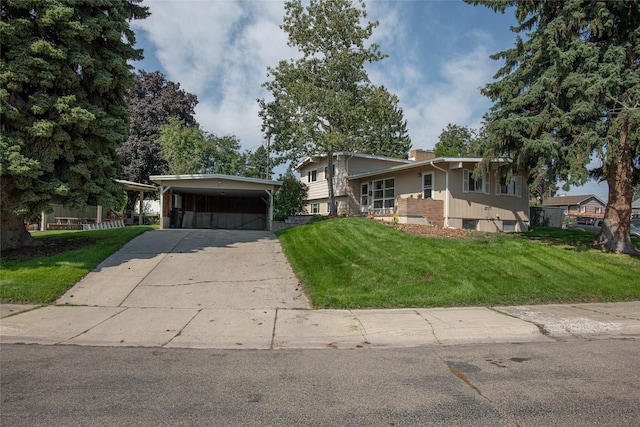 105 Sherwood Ln, Kalispell, MT 59901 - split level home featuring driveway, a front yard, a chimney, and a detached carport