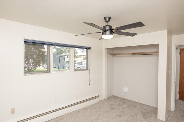 unfurnished bedroom featuring carpet flooring, ceiling fan, a baseboard heating unit, and a closet