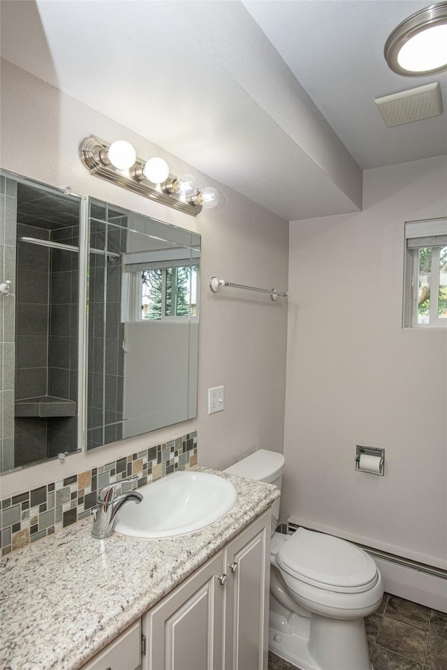 bathroom featuring plenty of natural light, vanity, decorative backsplash, and toilet