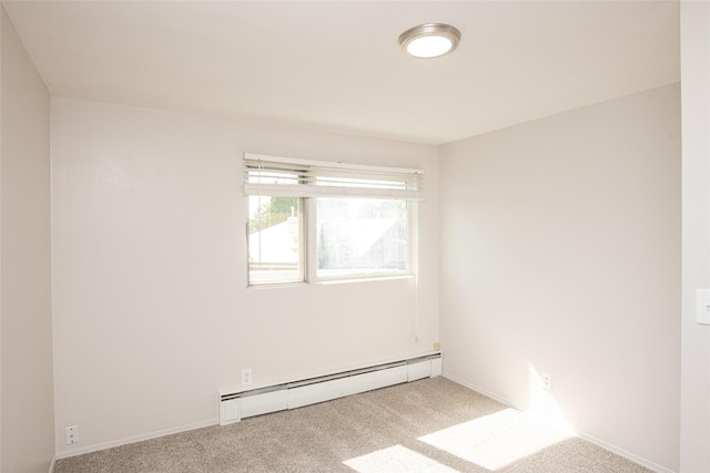 empty room featuring baseboards, a baseboard radiator, and carpet