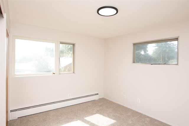 unfurnished room featuring baseboards, a baseboard radiator, and carpet