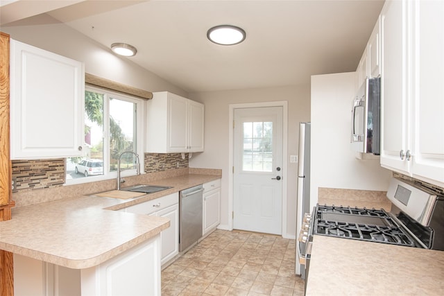 kitchen featuring backsplash, appliances with stainless steel finishes, and a healthy amount of sunlight