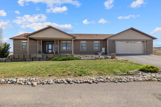 ranch-style home with a front yard and a garage