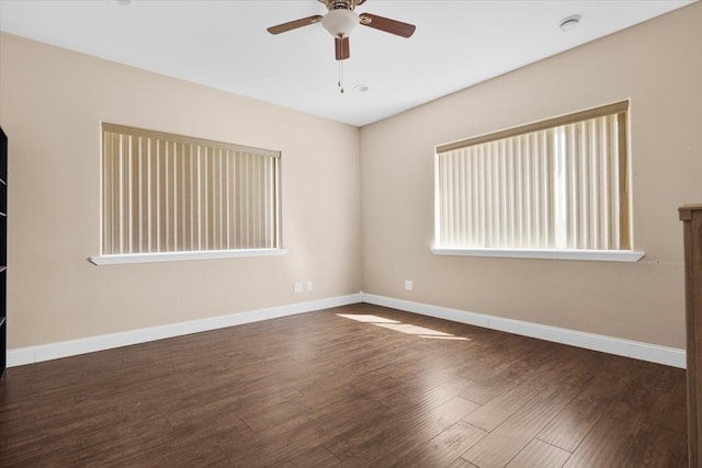 spare room with ceiling fan and dark hardwood / wood-style floors