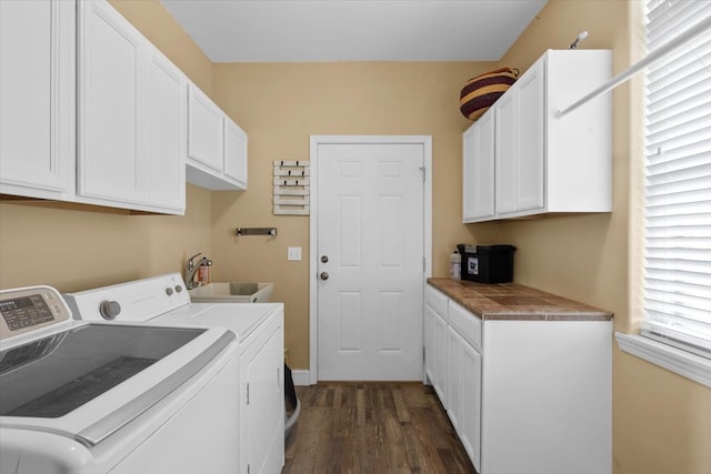 clothes washing area with washer and clothes dryer, sink, dark wood-type flooring, and cabinets