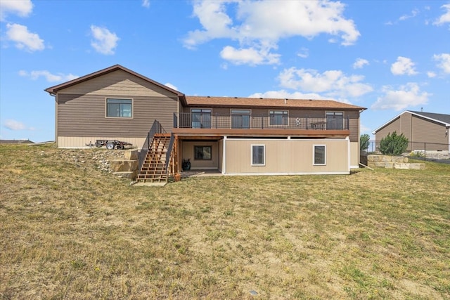 back of house with a wooden deck and a yard