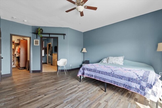 bedroom with wood-type flooring and ceiling fan