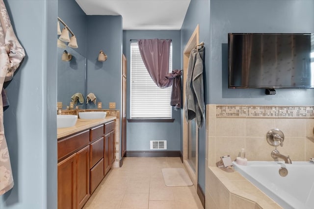 bathroom featuring tile patterned flooring, vanity, and separate shower and tub