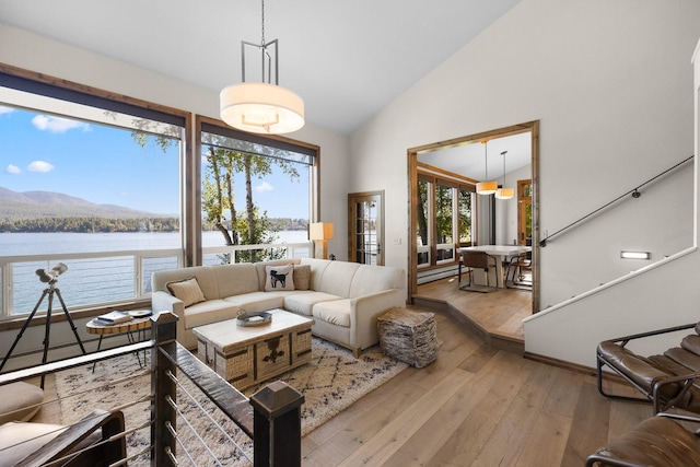 1320 W Lakeshore Dr, Whitefish, MT 59937 - living area with wood-type flooring, a water view, and high vaulted ceiling