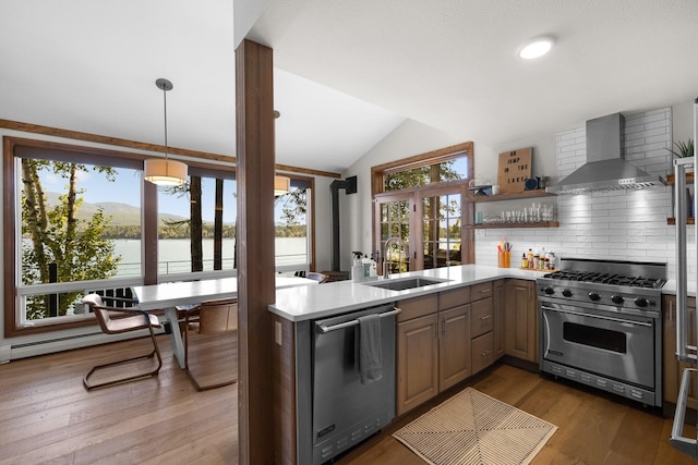 1320 W Lakeshore Dr, Whitefish, MT 59937 - kitchen featuring wall chimney exhaust hood, stainless steel appliances, lofted ceiling, backsplash, and light countertops