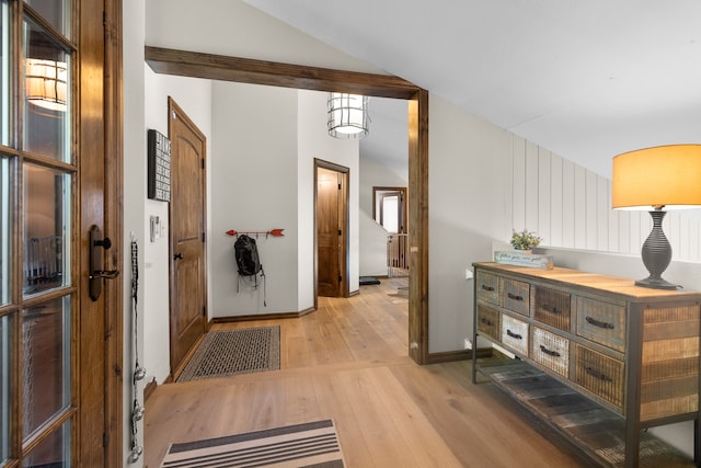 entrance foyer featuring vaulted ceiling and light hardwood / wood-style flooring