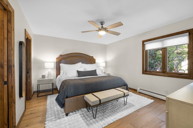 bedroom with baseboard heating, light hardwood / wood-style flooring, and ceiling fan