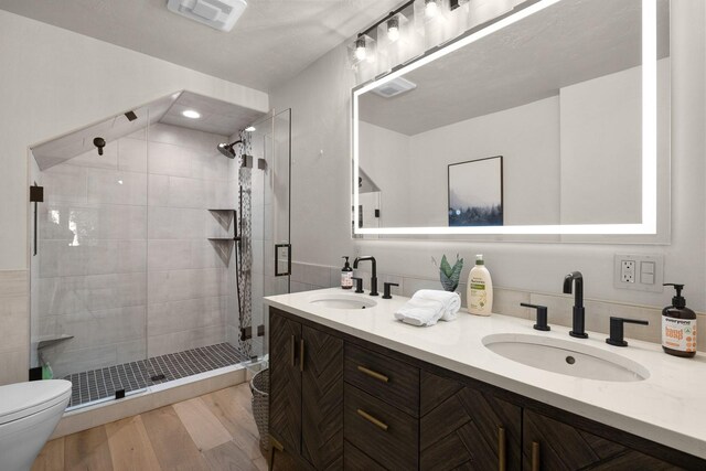 1320 W Lakeshore Dr, Whitefish, MT 59937 - bathroom with a shower stall, double vanity, and wood finished floors