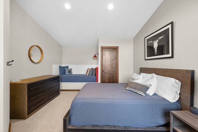 carpeted bedroom with lofted ceiling