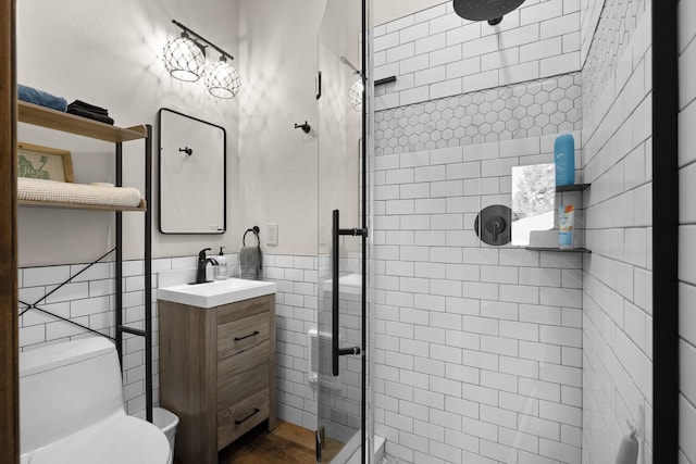 1320 W Lakeshore Dr, Whitefish, MT 59937 - bathroom with tile walls, a stall shower, vanity, and a wainscoted wall
