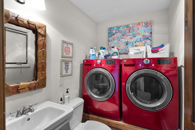 laundry room with washer and dryer and sink