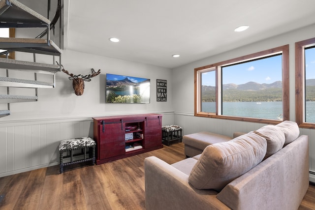 living room featuring a water and mountain view and dark hardwood / wood-style flooring