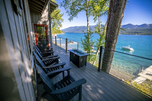 deck with a water and mountain view