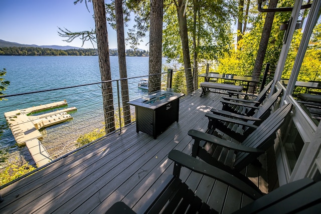 wooden terrace featuring a water view