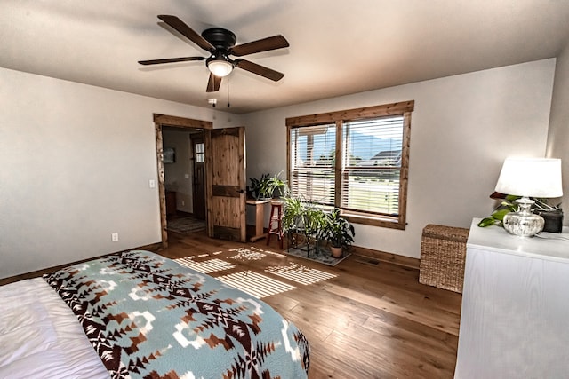 bedroom with ceiling fan and dark hardwood / wood-style flooring